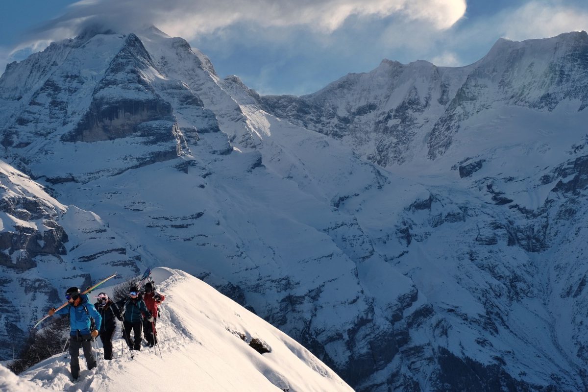 Skiers climbing a ridge above Murren, Switzerland