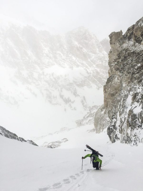Climbing a steep boot pack with skis in the Tetons